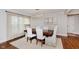Elegant dining room with a modern chandelier, hardwood floors, and ample natural light at 246 Westchester Blvd, Noblesville, IN 46062
