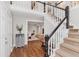 Bright foyer with hardwood floors, a staircase, and an elegant entry console at 246 Westchester Blvd, Noblesville, IN 46062