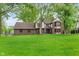 Charming two-story brick home featuring a large, lush green lawn and mature trees at 246 Westchester Blvd, Noblesville, IN 46062