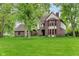 Charming two-story home showcasing a well-manicured lawn and mature trees at 246 Westchester Blvd, Noblesville, IN 46062