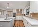 Well-lit kitchen featuring white cabinets, stainless steel appliances, subway tile backsplash, and wood-style flooring at 246 Westchester Blvd, Noblesville, IN 46062