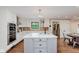 Bright kitchen featuring white cabinets, stainless steel appliances, and a gray kitchen island with marble countertop at 246 Westchester Blvd, Noblesville, IN 46062