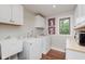 Functional laundry room with washer, dryer, sink, and ample storage at 246 Westchester Blvd, Noblesville, IN 46062