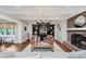 Inviting living room with a brick fireplace, modern shelving, and open access to dining and kitchen areas at 246 Westchester Blvd, Noblesville, IN 46062