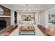 Cozy living room features fireplace, with an open view to a modern kitchen and dining space at 246 Westchester Blvd, Noblesville, IN 46062