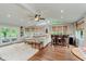 Open living area with a bar, wood floors, a plush rug, and abundant natural light at 246 Westchester Blvd, Noblesville, IN 46062