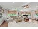 Bright living room featuring a cozy sectional sofa, wood floors, and large windows at 246 Westchester Blvd, Noblesville, IN 46062