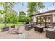 Inviting backyard patio with comfortable seating, a modern fire pit, and lush green lawn beyond at 246 Westchester Blvd, Noblesville, IN 46062