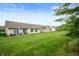 Expansive backyard view highlighting the lush lawn and the patio areas of the adjacent homes at 2717 W Long Meadow Ln, Muncie, IN 47304
