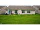 Well-maintained backyard featuring a patio set and lush green lawn, perfect for outdoor relaxation and entertaining at 2717 W Long Meadow Ln, Muncie, IN 47304