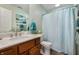 Well-lit bathroom with single sink, granite counter, wood cabinets, and a shower/tub combination at 2717 W Long Meadow Ln, Muncie, IN 47304
