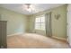 Clean bedroom with light green walls, neutral carpet, a ceiling fan, and a bright window at 2717 W Long Meadow Ln, Muncie, IN 47304