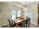 Bright dining room with a chandelier, table with seating for six, and sliding glass doors to the outside at 2717 W Long Meadow Ln, Muncie, IN 47304