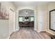 Inviting foyer featuring wood flooring, neutral paint, and an archway leading to the living room at 2717 W Long Meadow Ln, Muncie, IN 47304