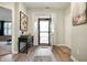 Inviting foyer with wood flooring, a console table, and view to the living room and front door at 2717 W Long Meadow Ln, Muncie, IN 47304