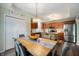 Bright eat-in kitchen with stainless steel appliances, wood cabinets, and a stylish chandelier over the wood table at 2717 W Long Meadow Ln, Muncie, IN 47304