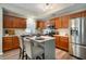 Modern kitchen featuring wood cabinets, stainless steel appliances, and a breakfast bar with seating at 2717 W Long Meadow Ln, Muncie, IN 47304
