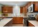 Well-lit kitchen features granite countertops, stainless steel appliances, and dark wood cabinets at 2717 W Long Meadow Ln, Muncie, IN 47304