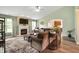 Cozy living room with a fireplace, large sectional, and view of the kitchen through an arched doorway at 2717 W Long Meadow Ln, Muncie, IN 47304
