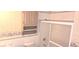 Bathroom featuring toilet, tiled shower, and decorative wallpaper at 3107 N 100 W, Shelbyville, IN 46176
