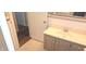 Bathroom with retro vanity and cabinet storage, plus an open doorway at 3107 N 100 W, Shelbyville, IN 46176