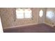 Well-lit bedroom featuring floral wallpaper, carpeted floor, and a large window at 3107 N 100 W, Shelbyville, IN 46176