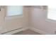 This room features hardwood floors, neutral striped wallpaper, and two windows with blinds at 3107 N 100 W, Shelbyville, IN 46176