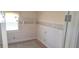 A simple room featuring neutral wallpaper, hardwood floors, a built-in shelf, and a window at 3107 N 100 W, Shelbyville, IN 46176