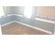Bedroom with two windows and light hardwood flooring at 3107 N 100 W, Shelbyville, IN 46176