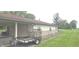 This angle highlights the home's brick foundation and connected carport at 3107 N 100 W, Shelbyville, IN 46176