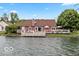 The back of the house has a large yard with a pier and easy access to the lake at 3403 Island Way, Indianapolis, IN 46214