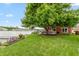 Backyard view, lawn, mature tree, and deck overlooking lake at 3403 Island Way, Indianapolis, IN 46214