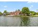 Waterfront home with a spacious deck, lush greenery, and easy access to the serene lake at 3403 Island Way, Indianapolis, IN 46214