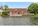 Beautiful backyard with a deck, cozy seating, manicured lawn, and direct access to the tranquil lake at 3403 Island Way, Indianapolis, IN 46214