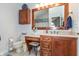 Bathroom featuring vanity, sink, decorative mirror, and convenient toilet placement at 3403 Island Way, Indianapolis, IN 46214