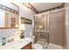 Full bathroom showcasing a shower, vanity sink, and decorative wallpaper at 3403 Island Way, Indianapolis, IN 46214
