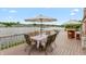 Deck overlooking lake with dining set shaded by white umbrella at 3403 Island Way, Indianapolis, IN 46214