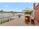Expansive deck overlooking a serene lake, complete with outdoor dining and entertaining space at 3403 Island Way, Indianapolis, IN 46214