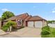 Charming single-Gathering home featuring a two-car garage, well-manicured lawn, and lakeside views at 3403 Island Way, Indianapolis, IN 46214
