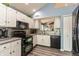 Well-lit kitchen showcasing white cabinets, modern appliances, and unique backsplash at 3403 Island Way, Indianapolis, IN 46214