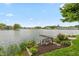Picturesque lake view with charming bench, manicured landscaping, and serene waterfront living at 3403 Island Way, Indianapolis, IN 46214