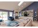 Spacious living room featuring vaulted ceilings, a fireplace, and built in storage space at 3403 Island Way, Indianapolis, IN 46214
