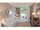 Cozy living room featuring a comfortable sofa, stylish mirror, and sliding glass doors to the outdoor deck at 3403 Island Way, Indianapolis, IN 46214