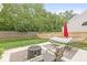 Spacious backyard with a hammock, patio seating, firepit and a wood privacy fence at 3803 Churchman Woods Blvd, Indianapolis, IN 46203
