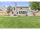 Spacious backyard with a lush lawn, patio with seating, hammock, privacy fence, and a storage shed at 3803 Churchman Woods Blvd, Indianapolis, IN 46203
