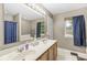 Double sink bathroom with a shower-tub combination and storage at 3803 Churchman Woods Blvd, Indianapolis, IN 46203