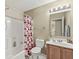 Bathroom featuring a shower and bath combo, toilet, vanity, and well lit mirror at 3803 Churchman Woods Blvd, Indianapolis, IN 46203