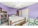 A bedroom features a window with bright walls, a ceiling fan, and closet space at 3803 Churchman Woods Blvd, Indianapolis, IN 46203