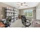 Bright bedroom featuring neutral walls, ceiling fan, large window and storage shelves with drawers at 3803 Churchman Woods Blvd, Indianapolis, IN 46203