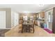 Open dining area with wood floors, table set for four, and sliding doors leading to the deck at 3803 Churchman Woods Blvd, Indianapolis, IN 46203